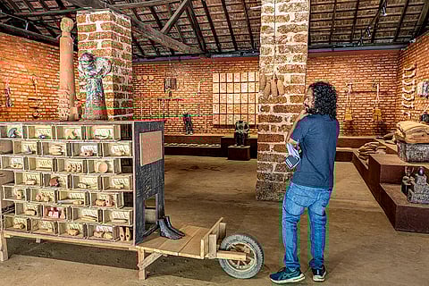 A visitor looks at an installation work by artist Birender Yadav, at the Kochi-Muziris Biennale in Kochi, Kerala. 