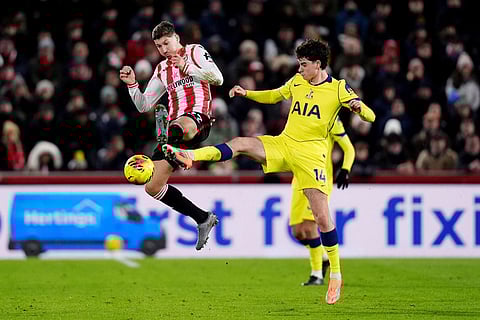 Brentford's Vitaly Janelt, left, and Tottenham Hotspur's Archie Gray in action during the English Premier League soccer match between Brentford and Tottenham Hotspur in London.