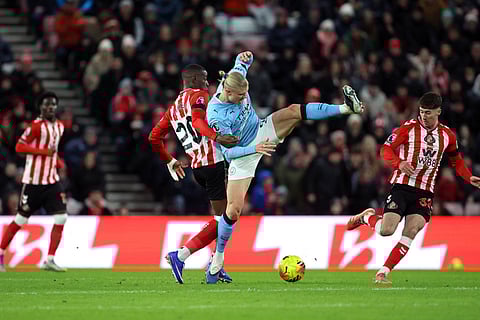 Sunderland's Nordi Mukiele and Manchester City's Erling Haaland, right, in action during the English Premier League soccer match between Sunderland and Manchester City in Sunderland, England.