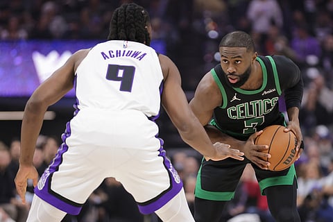 Boston Celtics guard Jaylen Brown (7) is guarded by Sacramento Kings forward Precious Achiuwa (9) during the first half of an NBA basketball game in Sacramento, California.