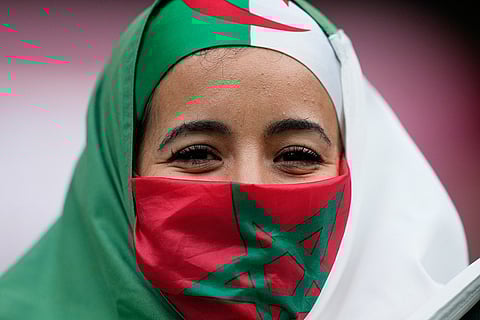 A fan wats for the start of the Africa Cup of Nations group E soccer match between Algeria and Sudan in Rabat, Morocco, Wednesday, Dec. 24, 2025. 