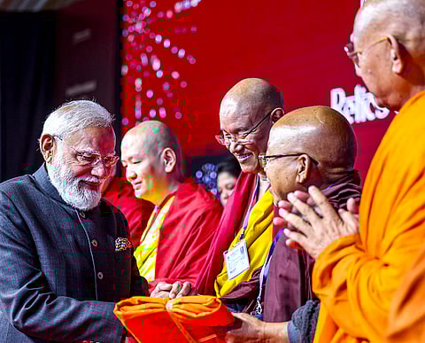 Prime Minister Narendra Modi greets monks during the inauguration of the grand international exposition of the sacred Piprahwa Relics, which were discovered in 1898, in New Delhi. Titled "The Light and the Lotus: Relics of the Awakened One," it is being hosted for a couple of months at the Rai Pithora Cultural Complex. 