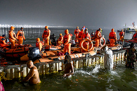 Devotees take a holy dip on the occasion of Paush Purnima during the Magh Mela in Prayagraj.