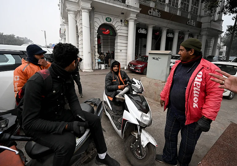 Gig workers rest during a nationwide strike at Connaught Place on December 31, 2025 in New Delhi, India. - IMAGO / Hindustan Times