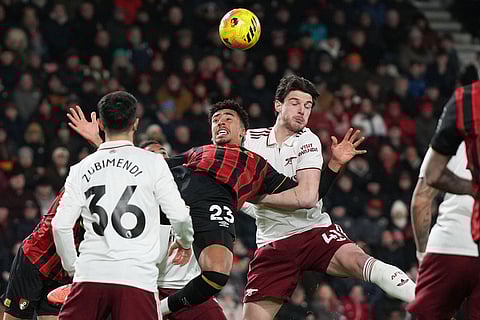 Arsenal's Declan Rice, right, challenges Bournemouth's James Hill during the English Premier League soccer match between Bournemouth and Arsenal in Bournemouth, England.
