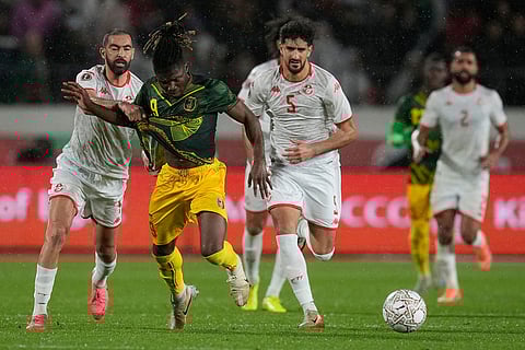 Tunisia's Yassine Meriah fouls Mali's El Bilal Toure during the Africa Cup of Nations best of 16 soccer match between Mali and Tunisia in Casablanca, Morocco.