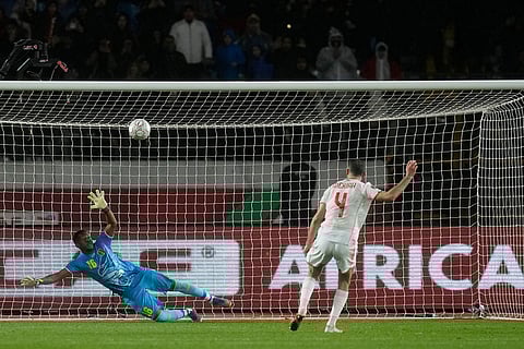 Tunisia's Yassine Meriah, right, scores a penalty kick against Mali's goalkeeper Djigui Diarra during the Africa Cup of Nations best of 16 soccer match between Mali and Tunisia in Casablanca, Morocco.