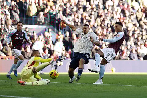 Aston Villa's Ollie Watkins, right, has a shot saved by Nottingham Forest goalkeeper John Victor during their English Premier League soccer match in Birmingham, England.