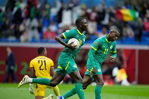 Senegal's Pape Alassane Gueye carries the ball after scoring during the Africa Cup of Nations best of 16 soccer match between Senegal and Sudan in Tangier, Morocco.