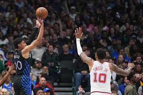 Dallas Mavericks guard Max Christie, left, shoots against Houston Rockets forward Jabari Smith Jr. (10) during the second half of an NBA basketball game in Dallas.
