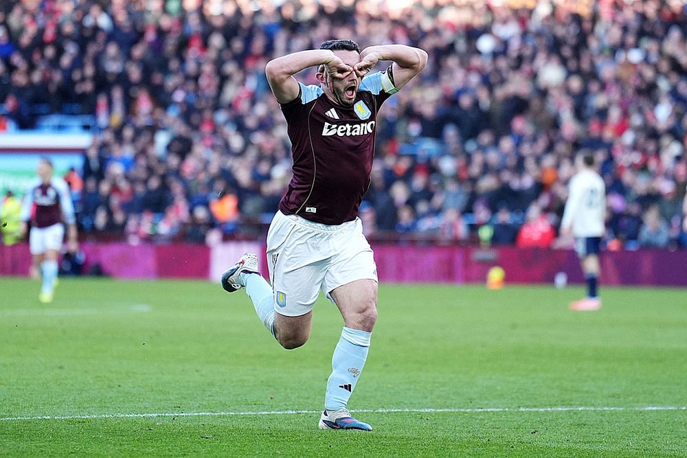 Aston Villa's John McGinn celebrates scoring their side's third goal during their English Premier League soccer match in Birmingham, England. - | Photo: Martin Rickett/PA via AP