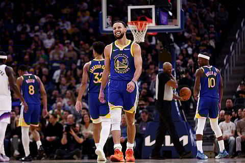 Golden State Warriors guard Stephen Curry (30) reacts in the third quarter during an NBA basketball game against the Utah Jazz in San Francisco.