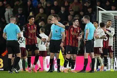 Bournemouth's players argue with referees after the English Premier League soccer match between Bournemouth and Arsenal in Bournemouth, England.