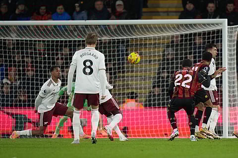 Bournemouth's Eli Junior Kroupi shoots to score his sides second goal during the English Premier League soccer match between Bournemouth and Arsenal in Bournemouth, England.