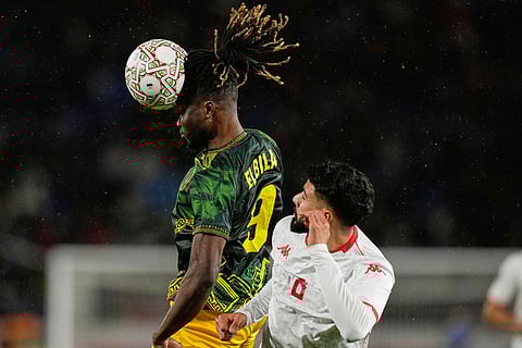 Mali's El Bilal Toure heaads the ball in front of Tunisia's Elias Saad during the Africa Cup of Nations best of 16 soccer match between Mali and Tunisia in Casablanca, Morocco.