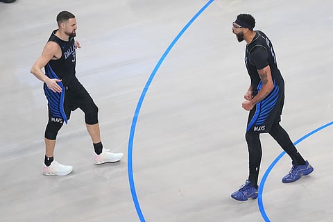 Dallas Mavericks forward Anthony Davis, right, and guard Klay Thompson react after a basket bay Davis against the Houston Rockets during the first half of an NBA basketball game in Dallas.