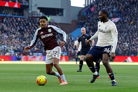 Aston Villa's Ian Maatsen, left and Nottingham Forest's Ola Aina battle for the ball during their English Premier League soccer match in Birmingham, England.