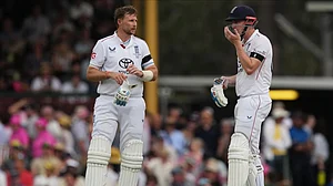 | Photo: AP/Mark Baker : England's Joe Root, left, and teammate Harry Brook talk during play on day one of the fifth and final Ashes cricket test between England and Australia in Sydney, Sunday, Jan. 4, 2026.