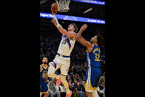Utah Jazz forward Lauri Markkanen (23) goes for a layup against Golden State Warriors forward Trayce Jackson-Davis (32) during the second half of an NBA basketball game in San Francisco.