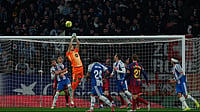 La Liga Matchday 18 Roundup: Barcelona Edge Espanyol As Garcia Steals Derby | Photo: AP/Joan Monfort : Barcelona's goalkeeper Joan Garcia, top, clears the ball during the Spanish La Liga soccer match between RCD Espanyol and Barcelona in Barcelona, Spain, Saturday, Jan. 3, 2026.