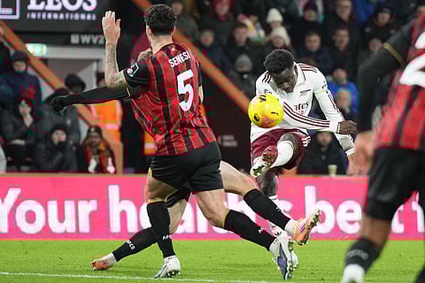 Arsenal's Bukayo Saka takes a shot during the English Premier League soccer match between Bournemouth and Arsenal in Bournemouth, England.
