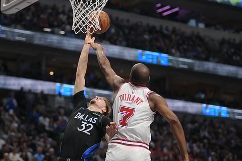 Houston Rockets forward Kevin Durant (7) blocks a shot attempt by Dallas Mavericks forward Cooper Flagg (32) during the second half of an NBA basketball game in Dallas.
