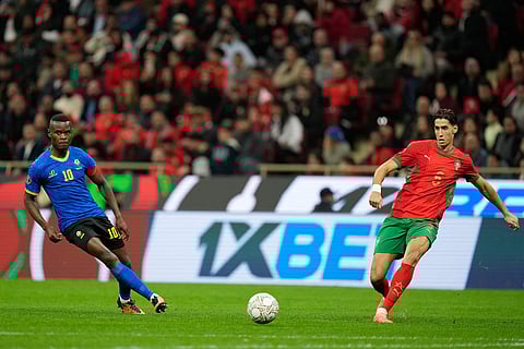 Tanzania's Mbwana Samatta, left, and Morocco's Nayef Aguerd vie for the ball during the Africa Cup of Nations round of 16 soccer match between Morocco and Tanzania in Rabat, Morocco.