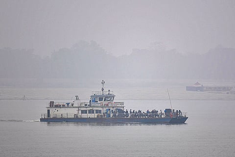 A ferry carries passengers across the Brahmaputra river on a winter morning, in Guwahati. 