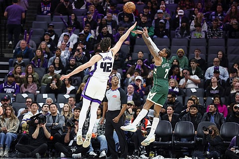 Milwaukee Bucks guard Kevin Porter Jr. (7) shoots a jump shot over Sacramento Kings center Maxime Raynaud (42) during the second half of an NBA basketball game in Sacramento, California. 