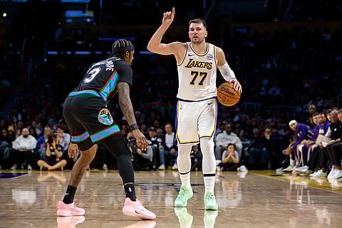 Los Angeles Lakers guard Luka Doncic (77) gestures during the second half of an NBA basketball game against the Memphis Grizzlies, in Los Angeles.