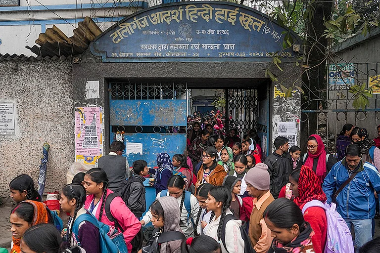 Students with their parents outside Tollygunge Adarsha Hindi High School amid concerns over the dilapidated condition of government schools, in Kolkata. - | Photo: PTI