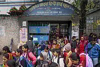| Photo: PTI : Students with their parents outside Tollygunge Adarsha Hindi High School amid concerns over the dilapidated condition of government schools, in Kolkata.