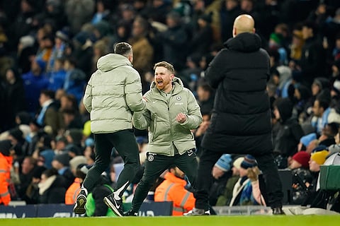 Chelsea's head coach Calum McFarlane, center, celebrates after Enzo Fernandez scoring during the English Premier League soccer match between Manchester City and Chelsea in Manchester, England.