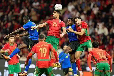 Morocco's Adam Masina (25) goes for a header during the Africa Cup of Nations round of 16 soccer match between Morocco and Tanzania in Rabat, Morocco.