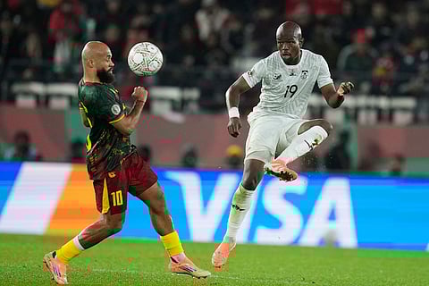 South Africa's Nkosinathi Sibisi and Cameroon's Bryan Mbeumo challenge for the ball during the Africa Cup of Nations round of 16 soccer match between South Africa and Cameroon in Rabat, Morocco.