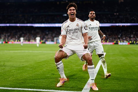 Real Madrid's Gonzalo Garcia celebrates after scoring his sides second goal during the Spanish La Liga soccer match between Real Madrid and Real Betis Sevilla in Madrid, Spain.