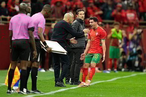 Morocco's Brahim Abdelkader Diaz, right, celebrates after scoring the opening goal during the Africa Cup of Nations round of 16 soccer match between Morocco and Tanzania in Rabat, Morocco.