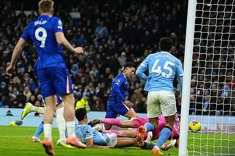Chelsea's Enzo Fernandez, center, scores his side's first goal during the English Premier League soccer match between Manchester City and Chelsea in Manchester, England.