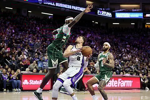 Sacramento Kings guard Zach Lavine (8) drives to the basket with Milwaukee Bucks forward Bobby Portis Jr., left, defending during the second half of an NBA basketball game in Sacramento, California. 