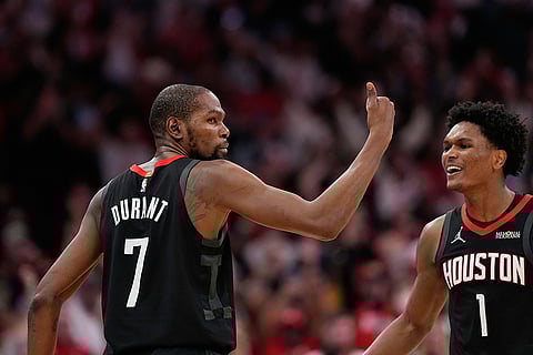 Houston Rockets' Kevin Durant (7) celebrates with Amen Thompson (1) after making a game-winning 3-point basket against the Phoenix Suns during the second half of an NBA basketball game in Houston. 