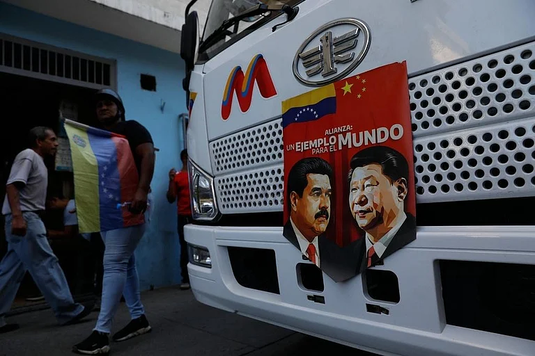A banner on the front end of a bus features images of Venezuelan President Nicolas Maduro and China's Xi Jinping with a message that reads in Spanish: "An example for the world," during a government-organized rally opposing U.S. intervention, in Caracas, Venezuela. - AP Photo/Cristian Hernandez