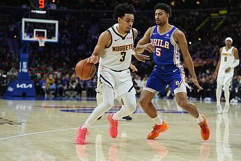 Denver Nuggets' Julian Strawther (3) tries to get past Philadelphia 76ers' Quentin Grimes (5) during the second half of an NBA basketball game in Philadelphia.