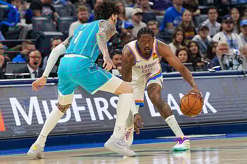 Oklahoma City Thunder guard Jalen Williams, right, looks for an opening past Charlotte Hornets guard LaMelo Ball, left, during the first half of an NBA basketball game, in Oklahoma City.