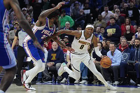 Denver Nuggets' Peyton Watson (8) tries to get past Philadelphia 76ers' Joel Embiid, second from right, during the second half of an NBA basketball game in Philadelphia. 