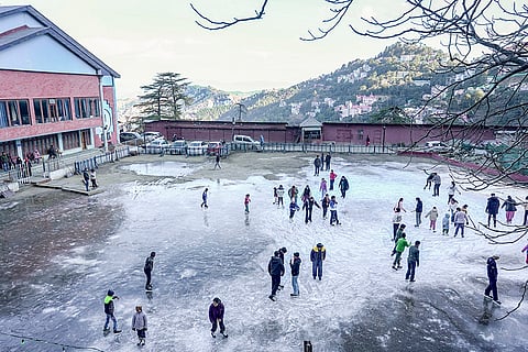 Skaters glide on an ice rink on a winter morning, in Shimla.