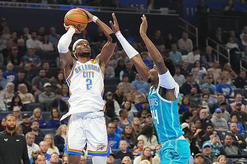 Oklahoma City Thunder guard Shai Gilgeous-Alexander, left, looks to shoot over Charlotte Hornets forward Brandon Miller, right, during the first half of an NBA basketball game in Oklahoma City. 