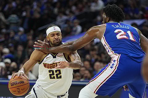 Denver Nuggets' Zeke Nnaji (22) tries to get past Philadelphia 76ers' Joel Embiid (21) during the second half of an NBA basketball game in Philadelphia.
