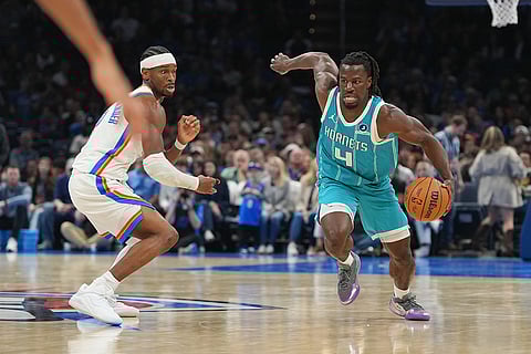 Charlotte Hornets guard Sion James, right, drives past Oklahoma City Thunder guard Shai Gilgeous-Alexander, left, during the second half of an NBA basketball game, in Oklahoma City.