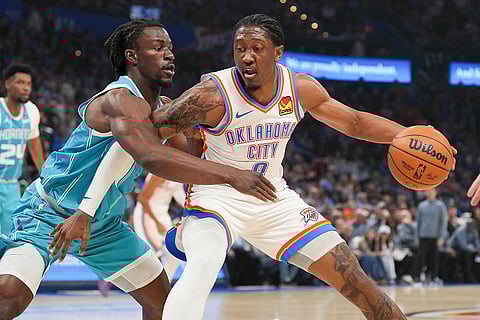 Oklahoma City Thunder guard Jalen Williams, right, pushes past Charlotte Hornets guard Sion James, left, during the first half of an NBA basketball game in Oklahoma City. 