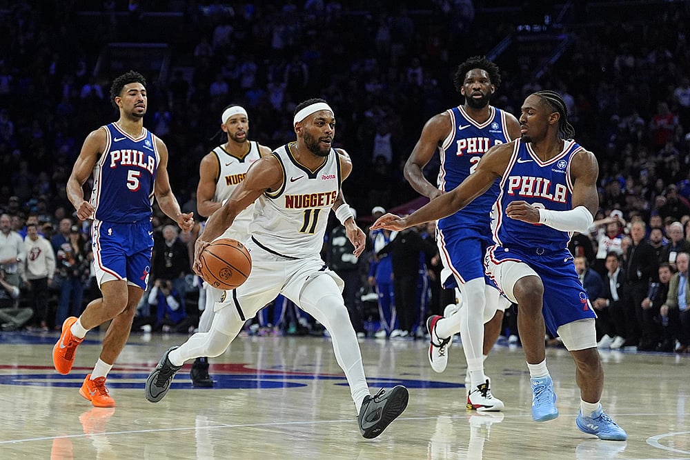 Denver Nuggets' Bruce Brown (11) tries to get past Philadelphia 76ers' Tyrese Maxey, right, during overtime of an NBA basketball game in Philadelphia.  - | Photo: AP/Matt Rourke